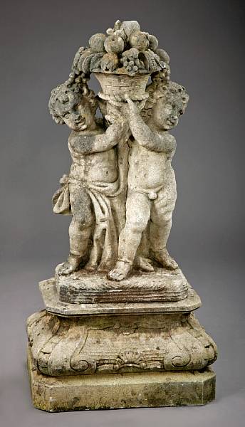 Appraisal: A cast stone figural group of two putti on pedestal