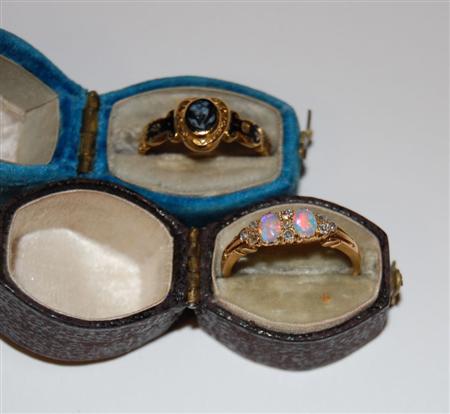 Appraisal: A diamond and opal ring claw set with two cabochon