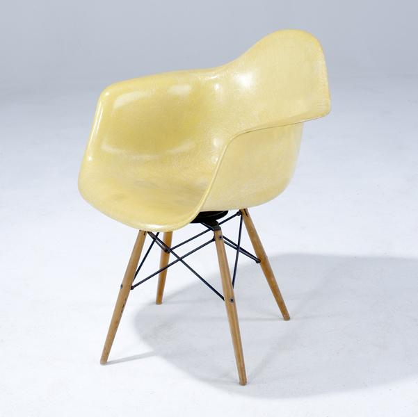 Appraisal: CHARLES AND RAY EAMES Early yellow fiberglass swivel chair with