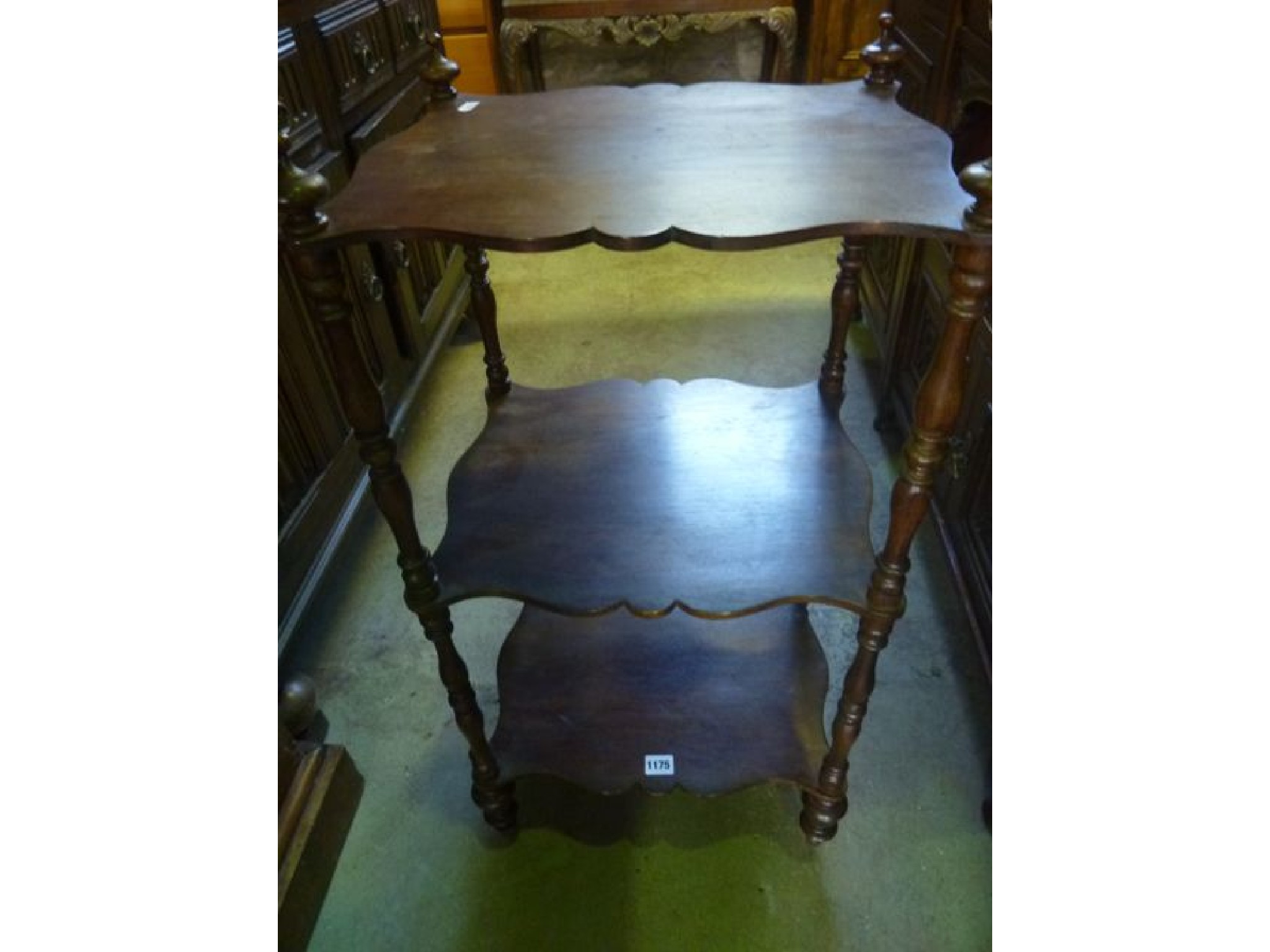 Appraisal: A Victorian walnut three tier whatnot the rectangular shelves with