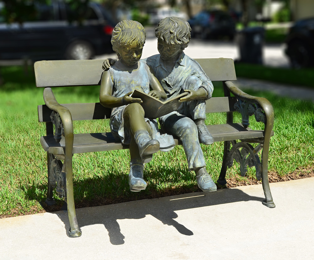 Appraisal: LARGE BRONZE SCULPTURE OF CHILDREN READING BOOK ON A BENCH