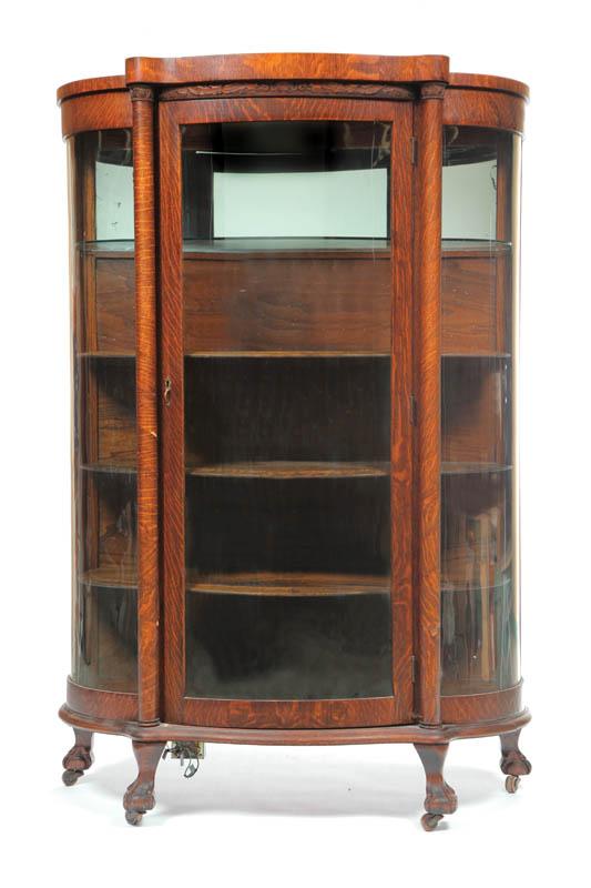 Appraisal: CHINA CABINET Oak having a foliate carved crest cylindrical columns