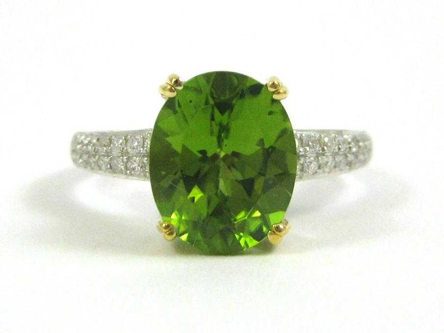 Appraisal: PERIDOT DIAMOND AND FOURTEEN KARAT GOLD RING The white and