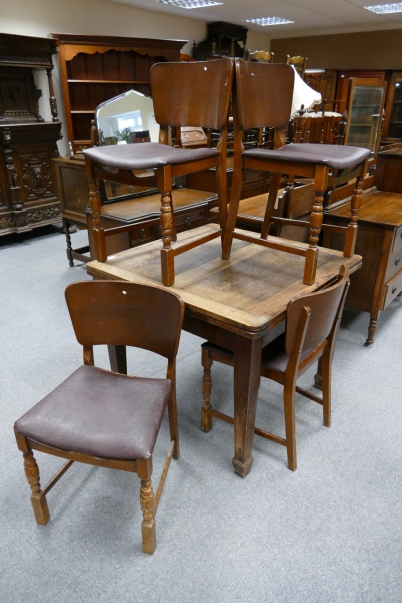 Appraisal: Oak pull out dinning table with mid-century leather seated dinning