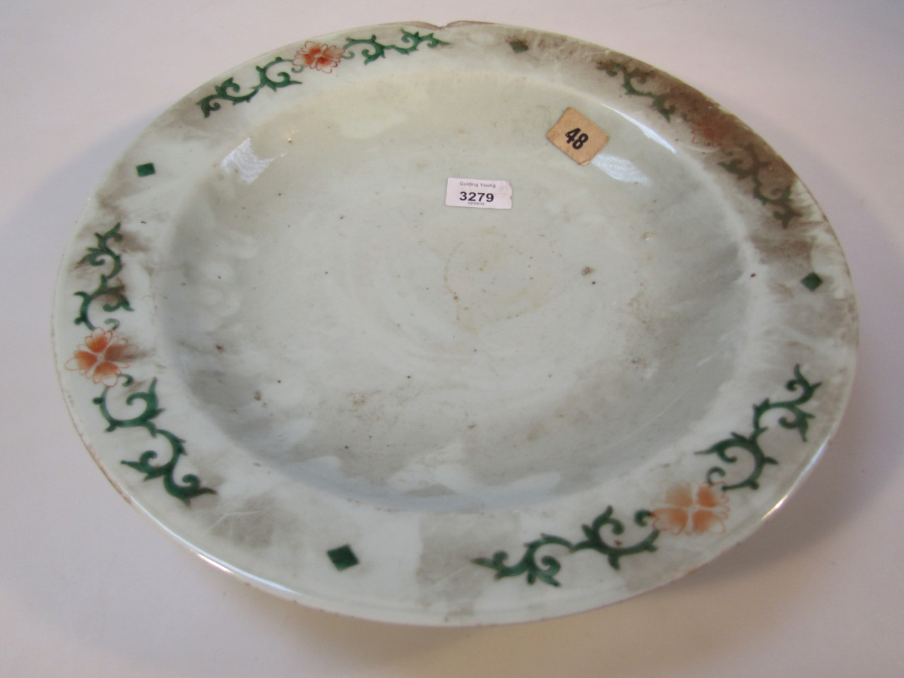 Appraisal: A Chinese earthenware dish sparsely decorated in Ming style palette