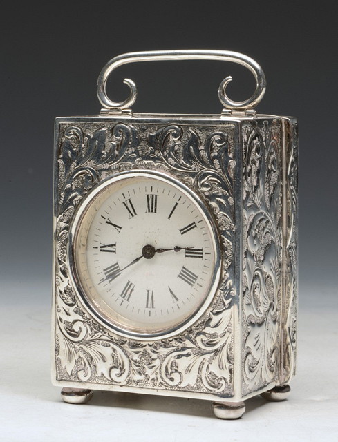 Appraisal: A FRENCH CARRIAGE CLOCK with embossed silver case and acanthus