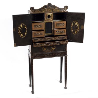 Appraisal: A Chinese export lacquered cabinet on stand the shaped pediment