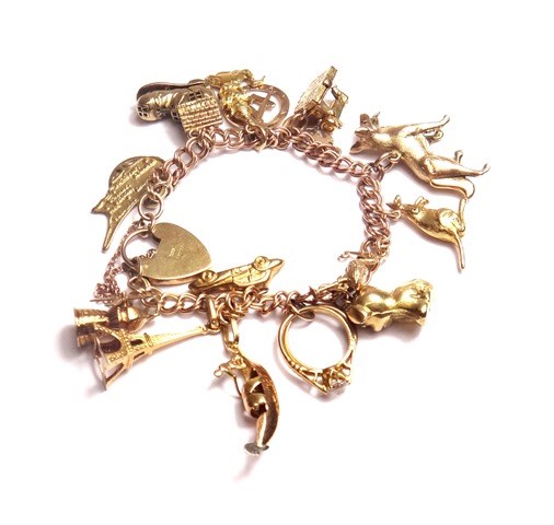 Appraisal: A ct gold twin curb link charm bracelet fitted with