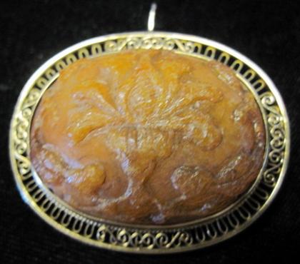 Appraisal: karat yellow gold amber pendantFloral amber carving accented by a