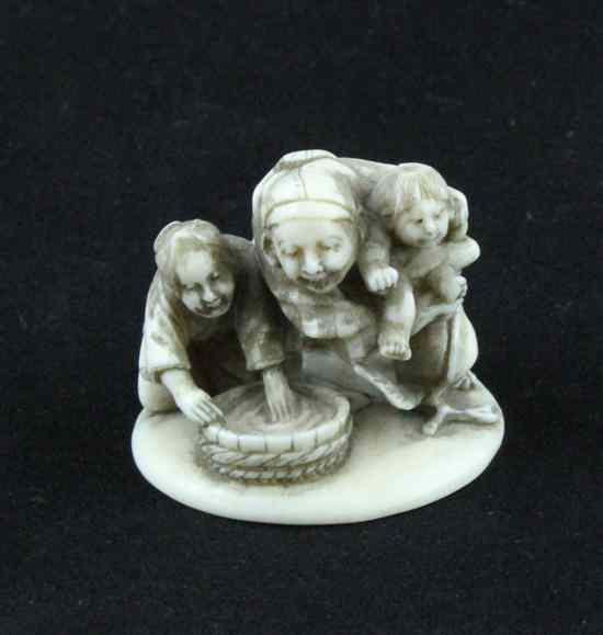 Appraisal: A Meiji period ivory ojime carved as a couple bathing