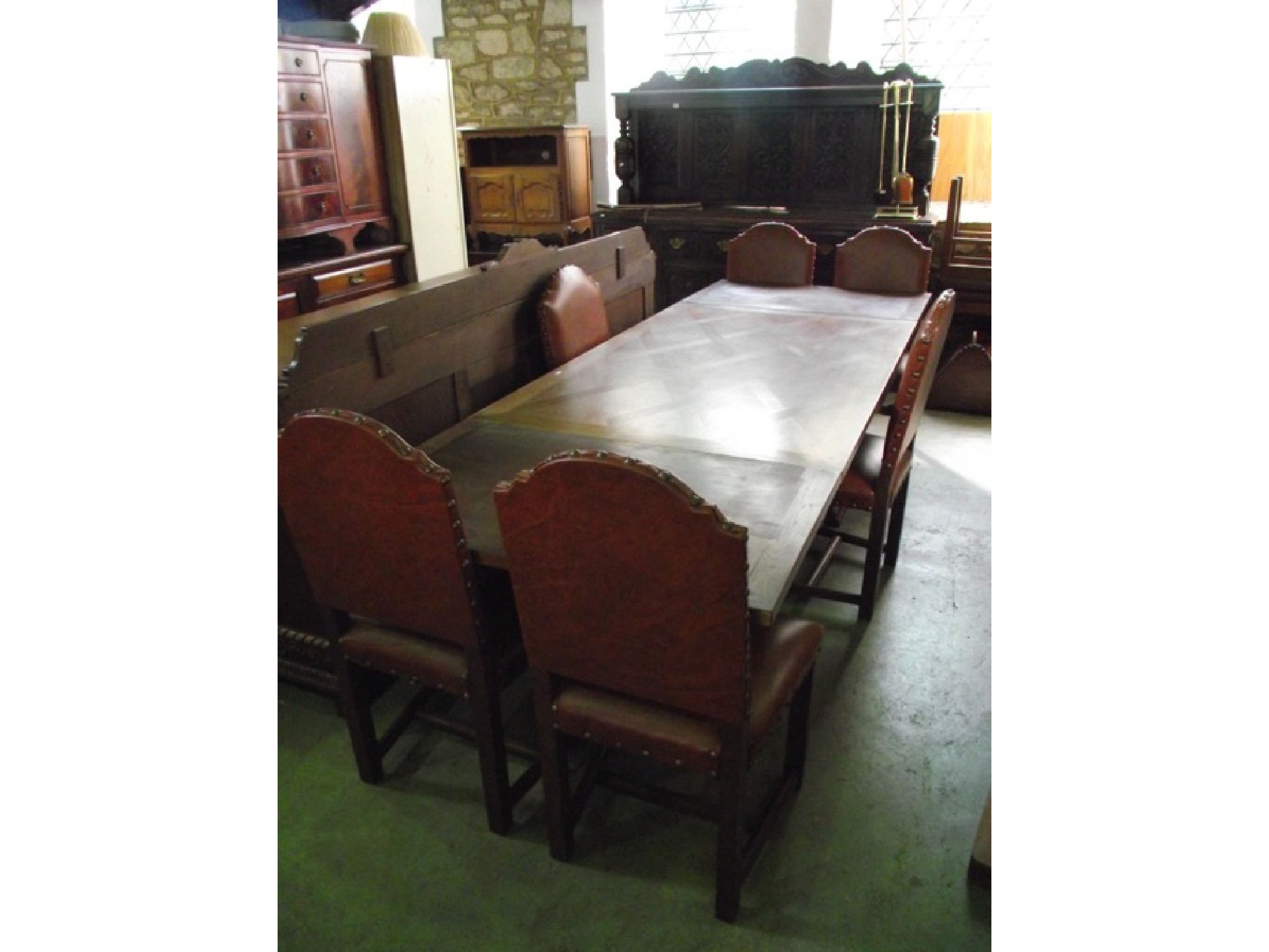 Appraisal: A substantial medium oak dining room suite comprising draw leaf