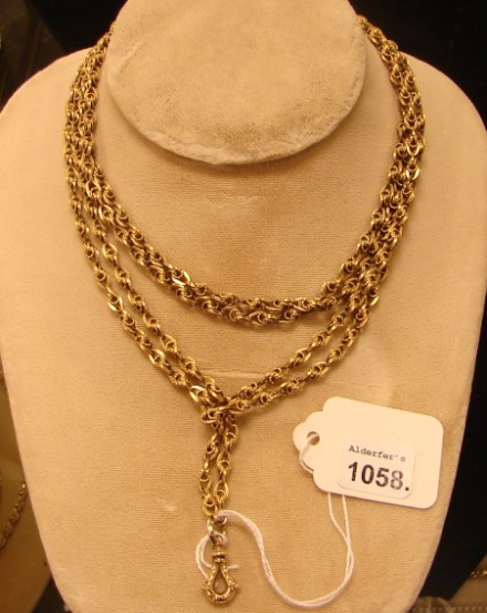 Appraisal: KY long chain with long gold filled decorative swivel grams