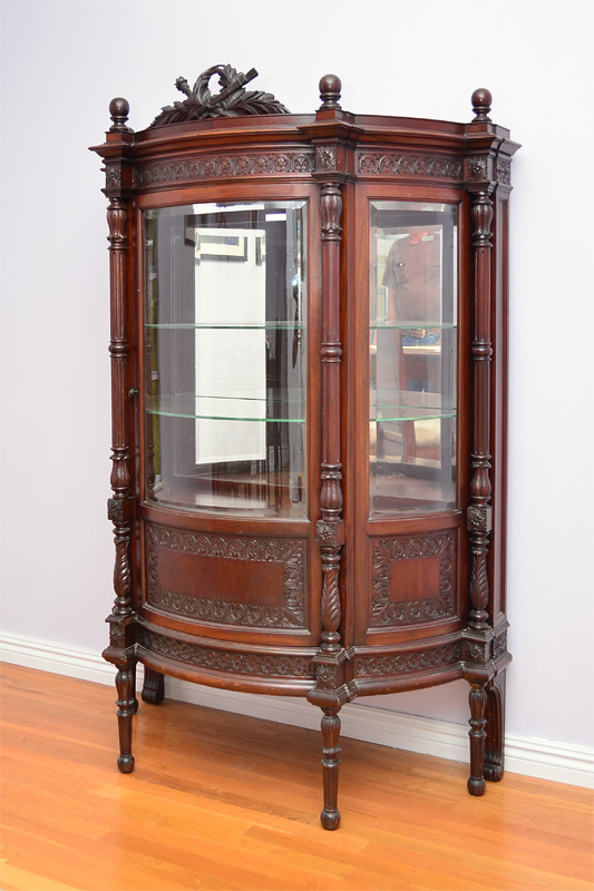 Appraisal: HIGH VICTORIAN MAHOGANY BOW FRONT CHINA CABINET Carved all over