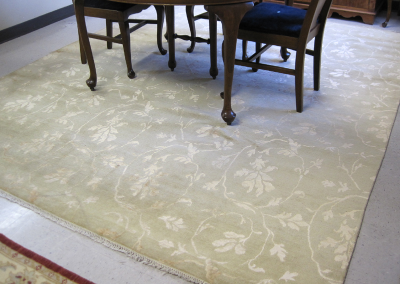 Appraisal: HAND KNOTTED ORIENTAL CARPET featuring white floral tracery on borderless