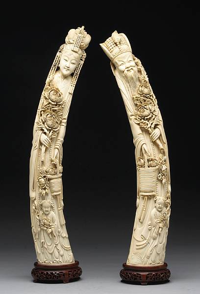 Appraisal: A pair of large ivory emperor and empress figures Each