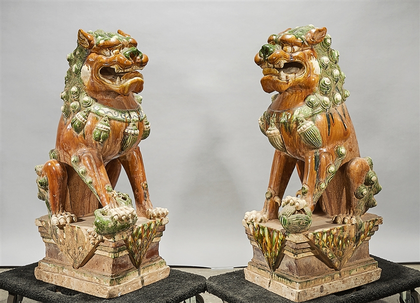 Appraisal: Pair of Chinese sancai-style glazed pottery fo lions x x