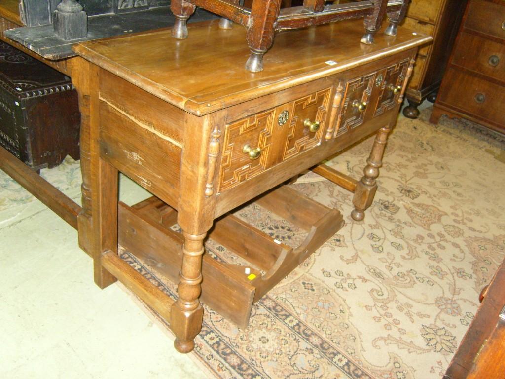 Appraisal: A small oak dresser base in the Jacobean style fitted