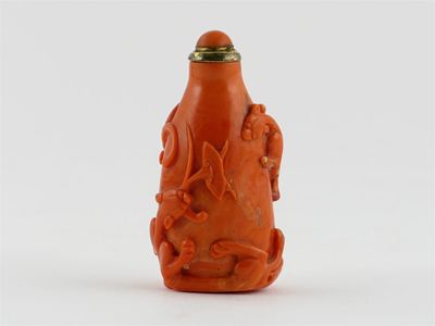 Appraisal: A Chinese coral snuff bottle carved in relief with two