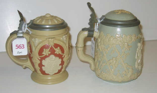 Appraisal: METTLACH TWO BEER STEINS No liter decorated in relief with