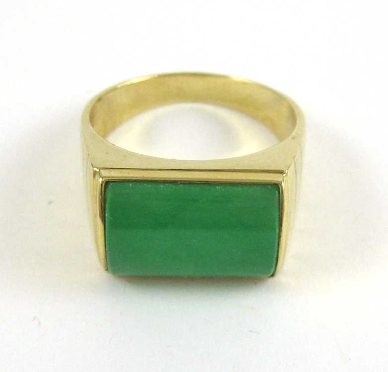 Appraisal: GREEN JADE AND FOURTEEN KARAT GOLD RING bezel set with