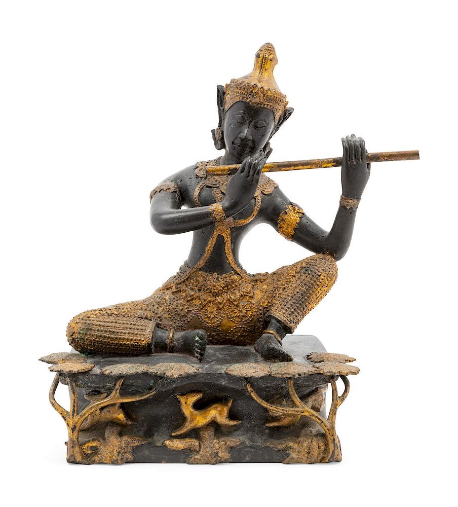 Appraisal: A Thai Gilt and Patinated Bronze Flute Player A Thai