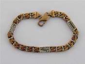 Appraisal: A carat gold bracelet composed of two colour flattened curb