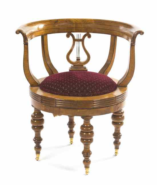 Appraisal: A Biedermeier Birch Swivel Chair having a demilune crest rail