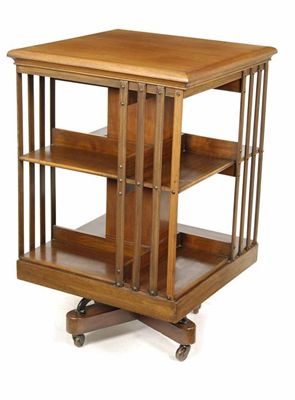 Appraisal: An Edwardian walnut revolving bookcase on ceramic castors in cm