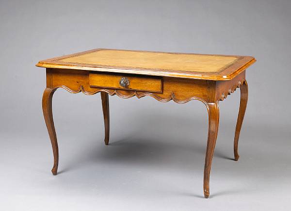 Appraisal: A Louis XV walnut bureau plat The rectangular top with