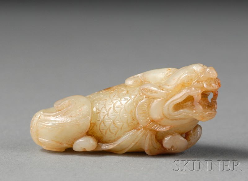 Appraisal: Jade Carving of a Mythical Animal yellow-green stone with russet