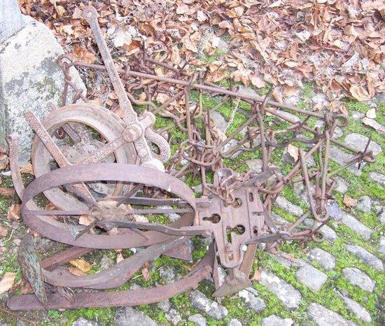 Appraisal: An iron pulley wheel with brakes plough blades small chain