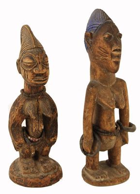 Appraisal: Two Yoreba Ibeji figures with bead and metal bangles and