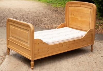 Appraisal: A pine single bed with mattress rounded edges to head