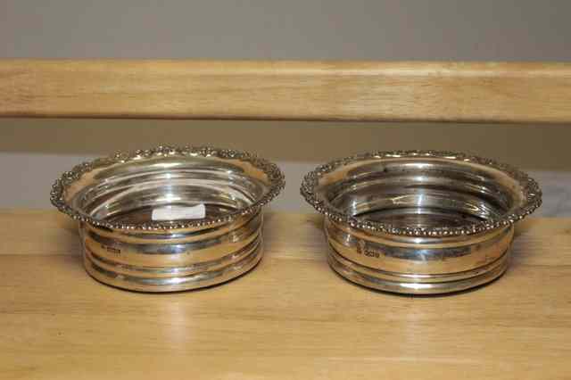 Appraisal: A PAIR OF GEORGE V SILVER AND MAHOGANY TURNED WINE