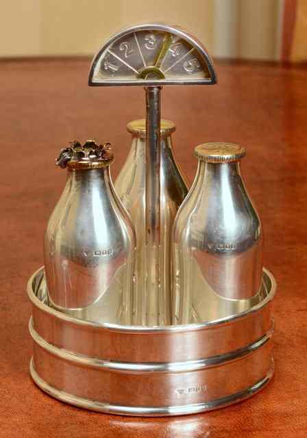 Appraisal: A SILVER CRUET SET in the form of milk bottles