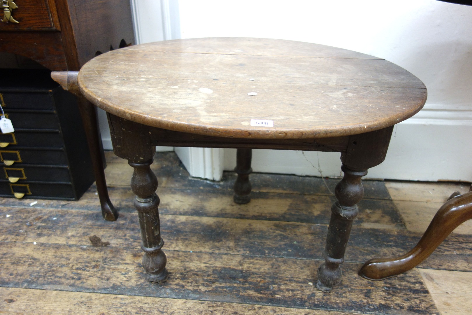 Appraisal: A George III circular oak table top on an associated