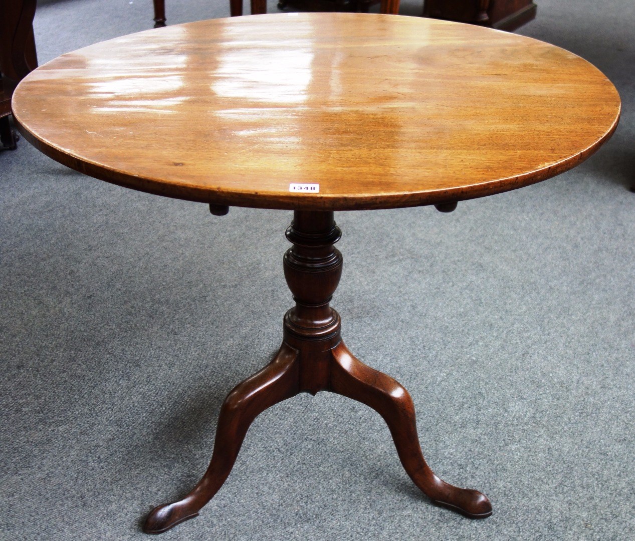 Appraisal: An th century mahogany circular snap top occasional table on