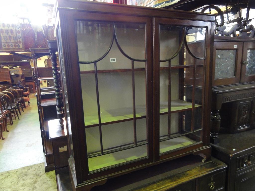 Appraisal: An Edwardian mahogany display cabinet enclosed by a pair of