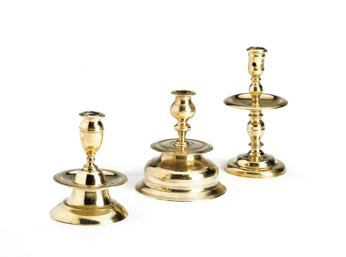 Appraisal: THREE CONTINENTAL BRASS CANDLESTICKS INCLUDING A DUTCH EXAMPLE PROBABLY HEEMSKERK