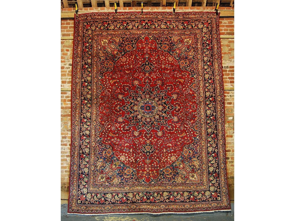 Appraisal: A handmade Persian carpet the geometric and floral designs on