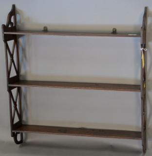 Appraisal: Mahogany hanging shelf having openwork sides and tiers of shelves