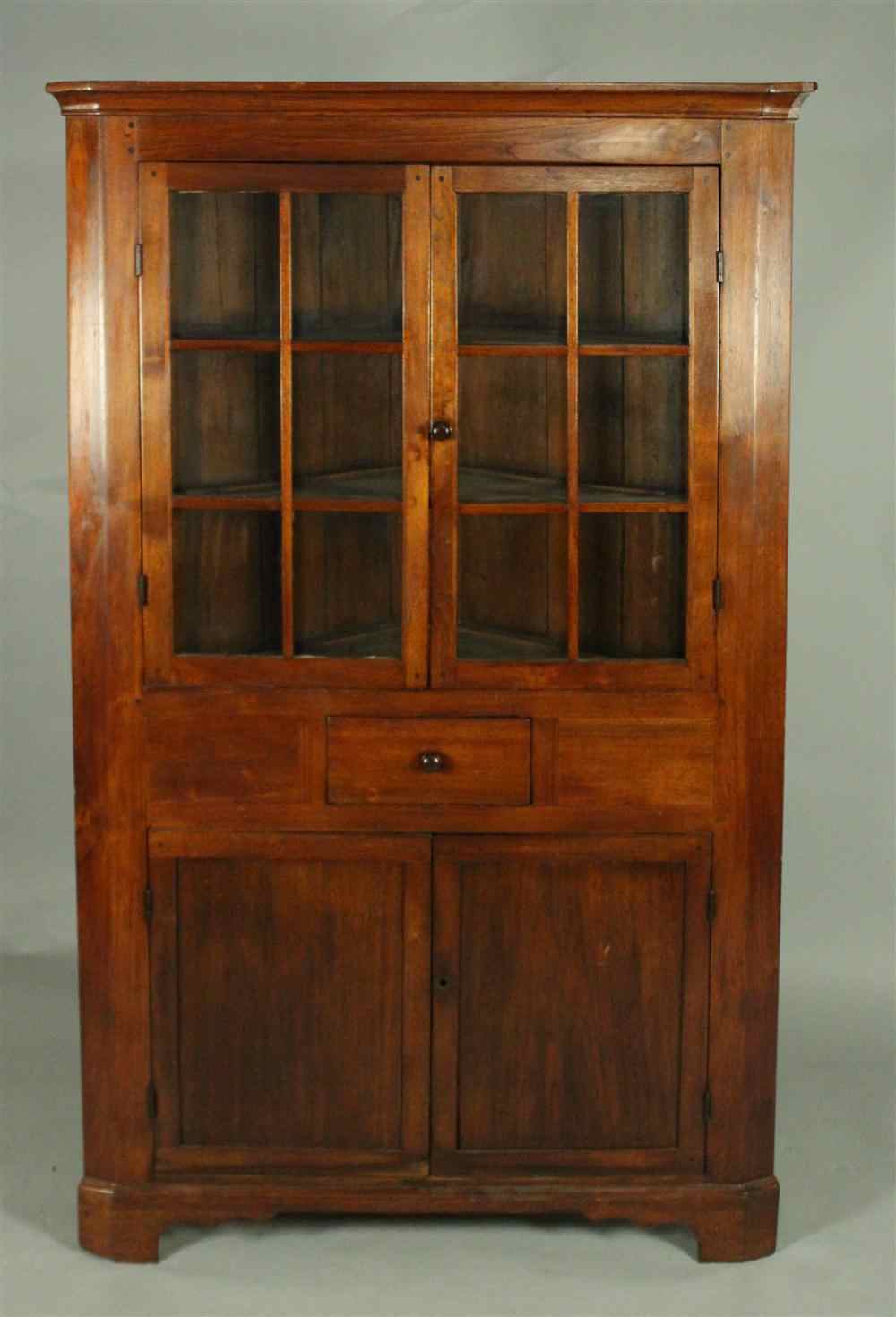 Appraisal: AMERICAN WALNUT CORNER CUPBOARD th century in one piece having