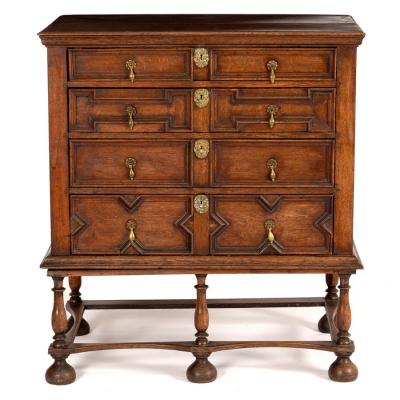 Appraisal: An oak chest of Jacobean design fitted four long drawers