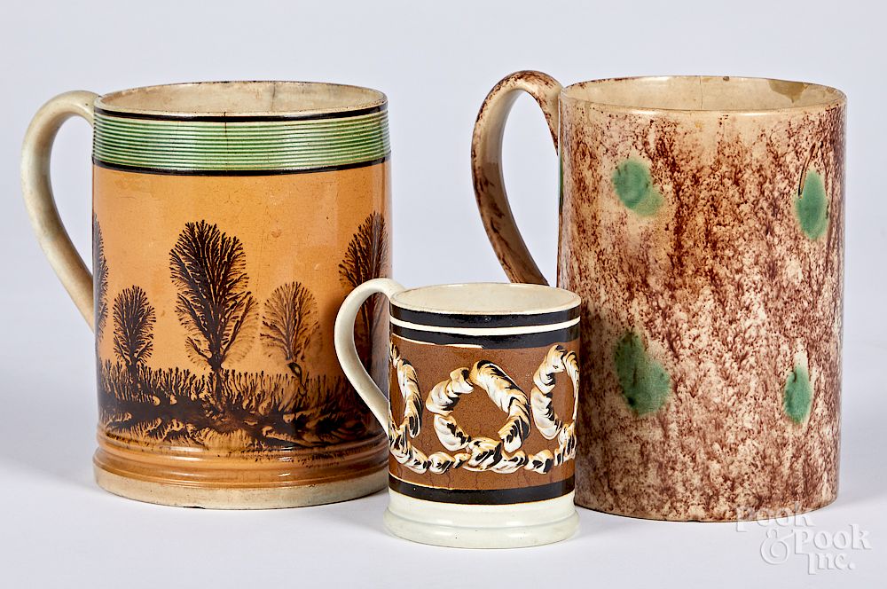 Appraisal: Three mocha mugs Three mocha mugs th c with seaweed