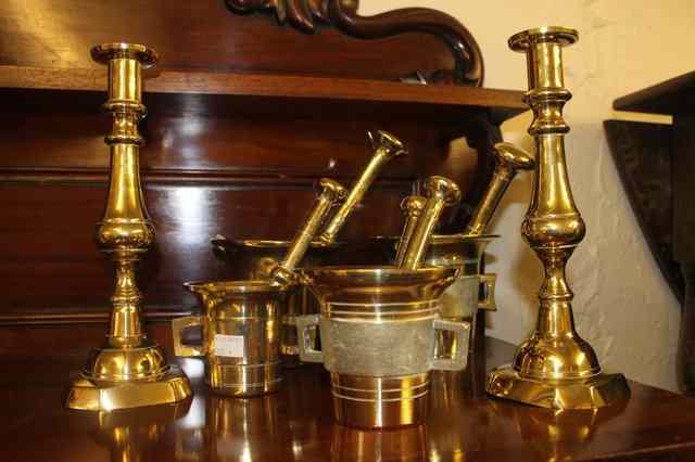 Appraisal: A PAIR OF VICTORIAN BRASS CANDLESTICKS and five brass pestle