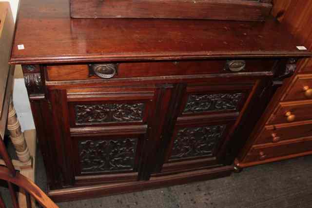 Appraisal: A MAHOGANY SIDE CABINET with single drawer over carved panelled