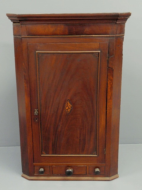 Appraisal: Georgian mahogany hanging corner cupboard with a molded cornice above