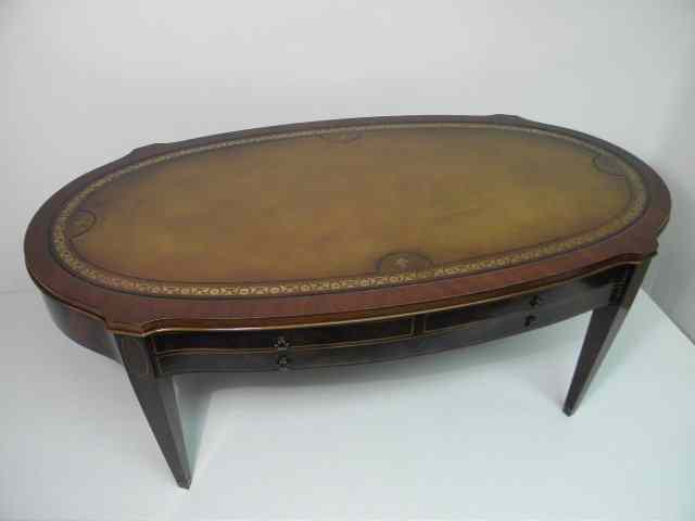 Appraisal: Mahogany leather top coffee table Impressed and gilt fluer-de-lis symbols