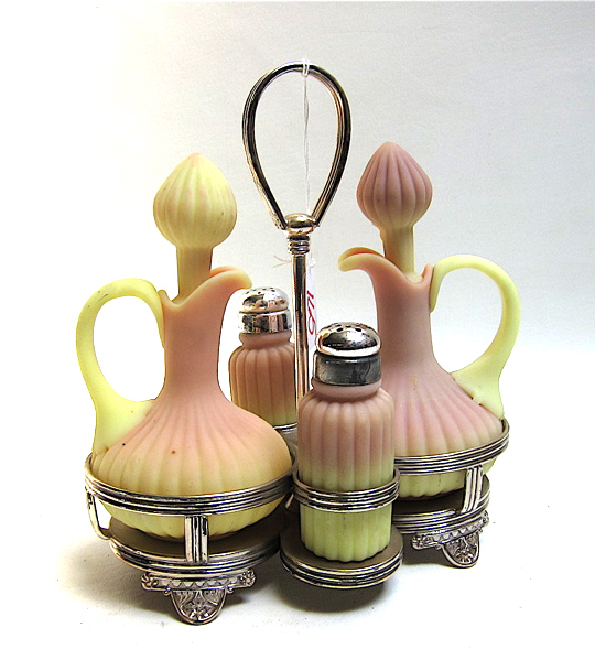 Appraisal: MOUNT WASHINGTON BURMESE GLASS CRUET SET in conforming Pairpoint silver