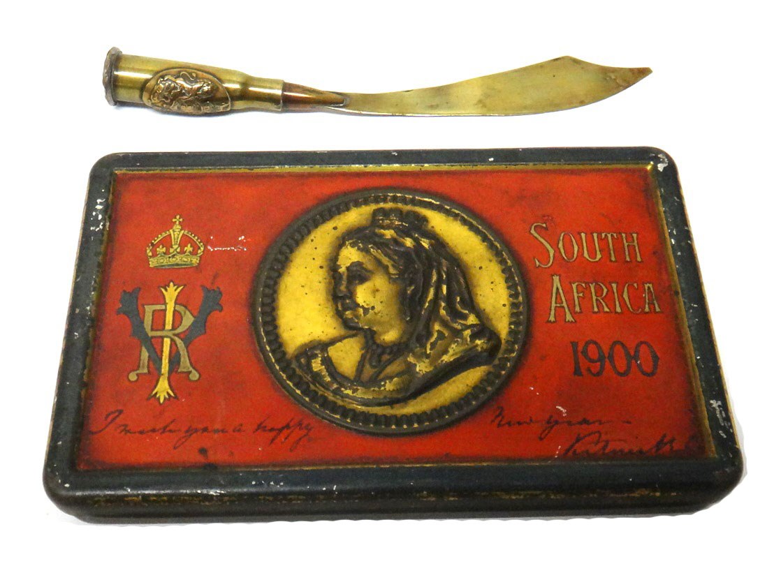 Appraisal: A Victorian Boer War chocolate tin containing the remains of